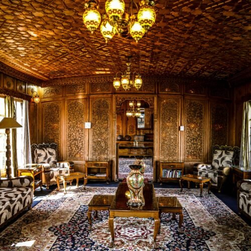 Hand-carved walnut wood interior of a luxury houseboat on Dal Lake in Srinagar, Kashmir.