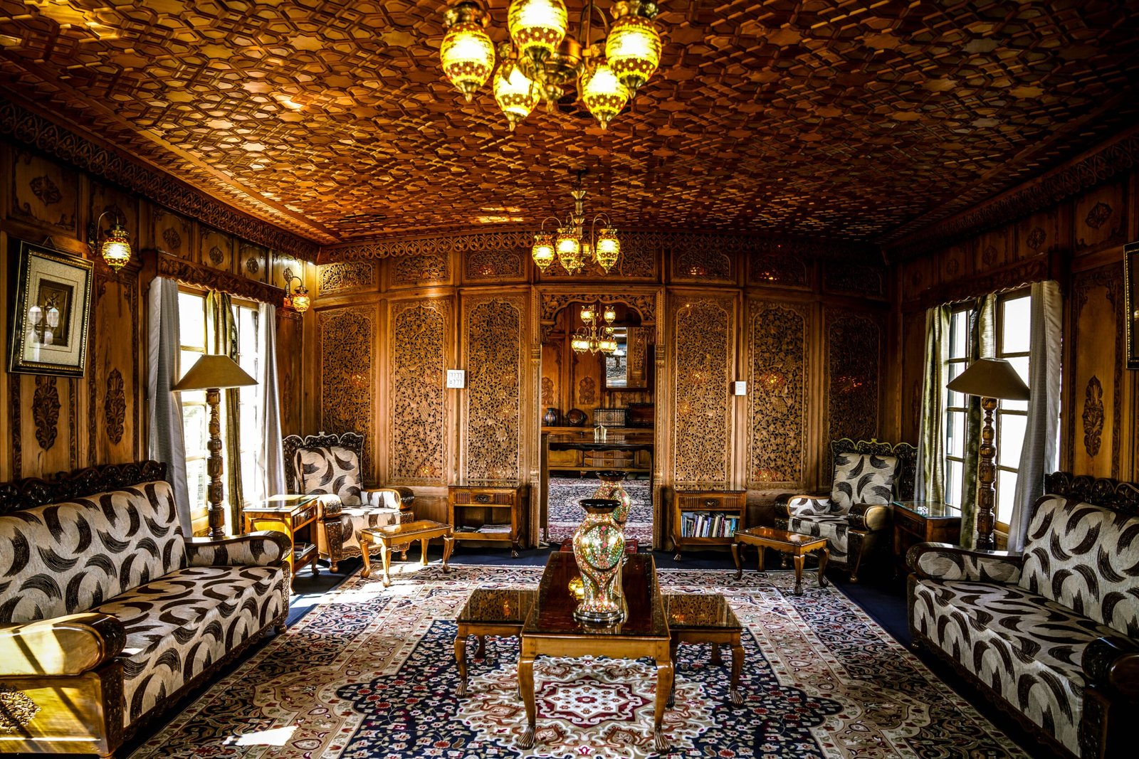 Hand-carved walnut wood interior of a luxury houseboat on Dal Lake in Srinagar, Kashmir.